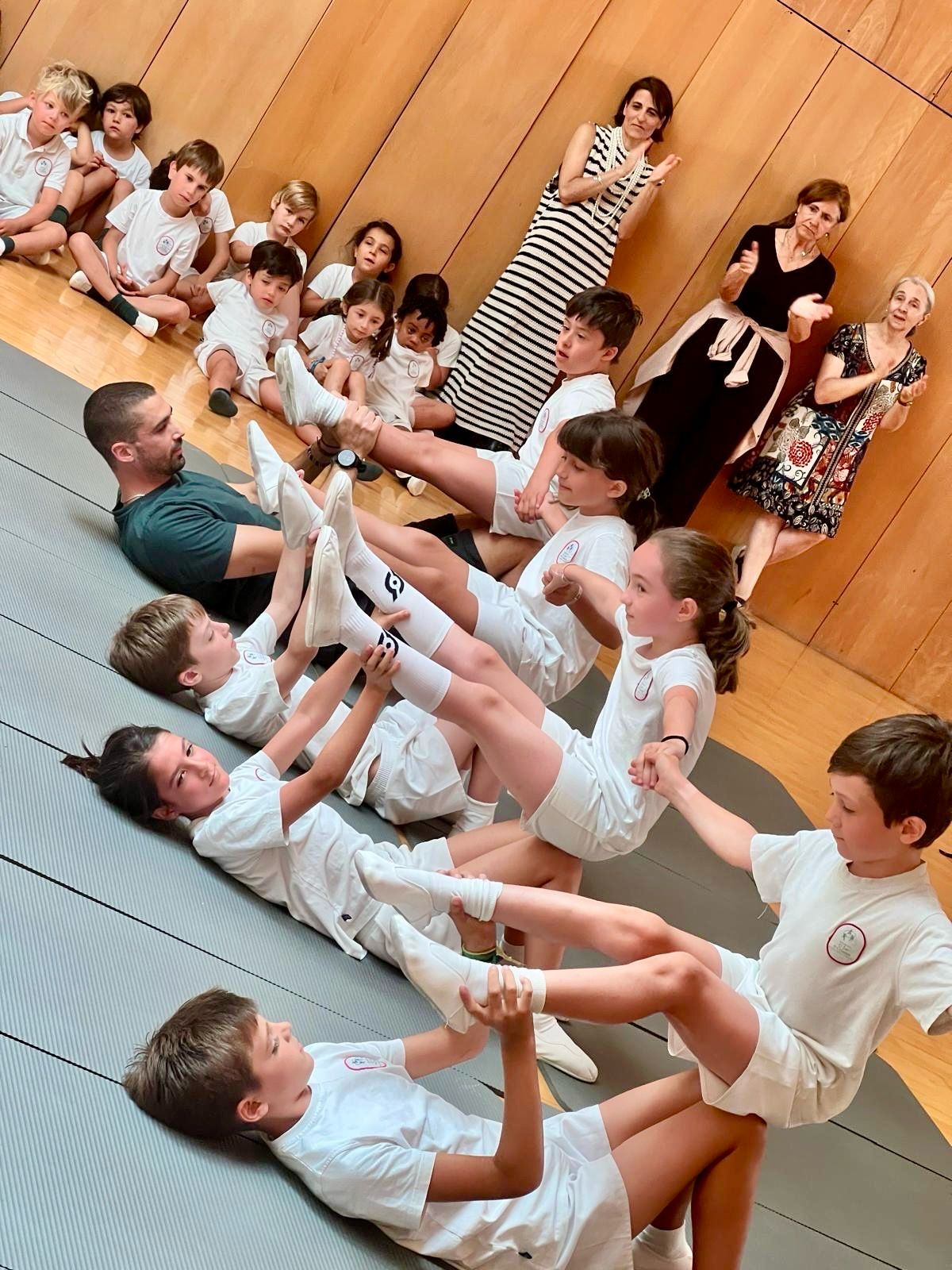 Judo class with pupils practising exercises in pairs
